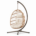 Sillón colgante de ratán y metal con cojines crema